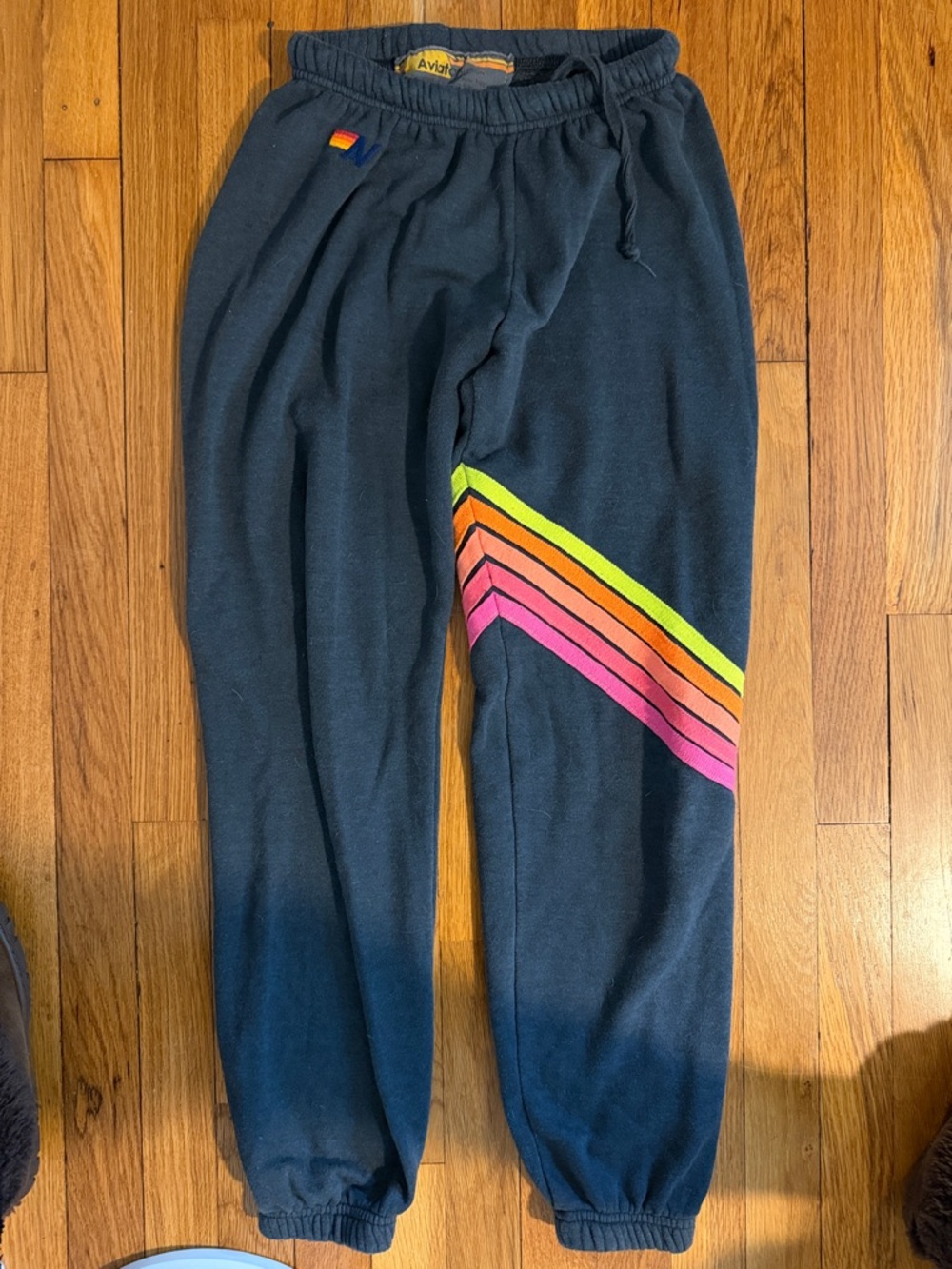 Aviator Nation Charcoal Pants with neon yellow, pink and orange chevron pattern.